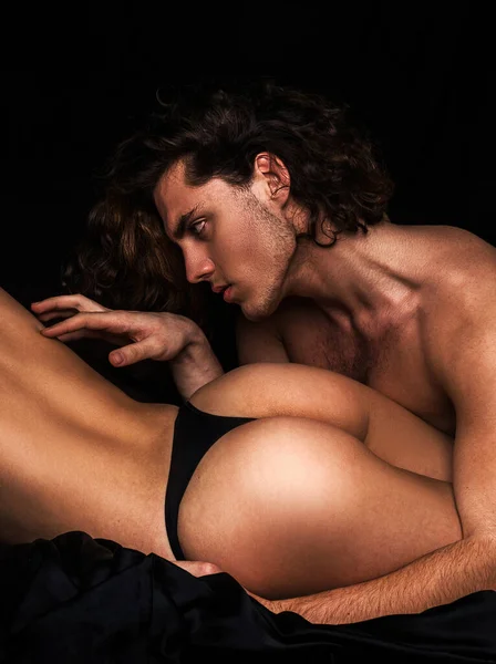 Sensual couple. Sensual attractive woman ass. Advertising and commercial design. Parts of woman body in underwear. Couple in love. Moments of intimacy. Muscular man. Huge buttocks. — Stockfoto