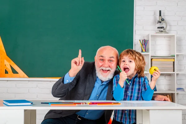 Grandfather and son having fun together. Science education concept.