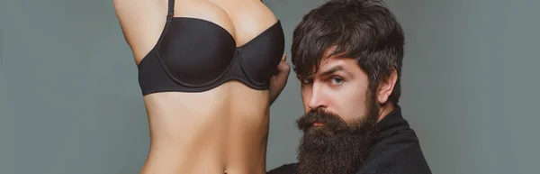 Prelude and foreplay before sex. Hot girl with big natural tits wearing black bralette. Handsome bearded man touching womans body and enjoying her beautiful boobs. — Stockfoto