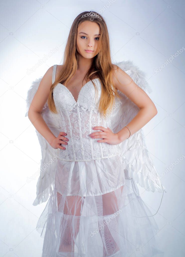 Festive Art Greeting Card. Cupid girl aiming at someone with an arrow of love. Angel in love. Angelic face. Pretty girl as the cupid with a wings congratulating on St Valentines day.