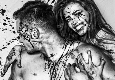 Cadılar Bayramı 'nda yakışıklı bir çift ve uzun saçlı seksi bir kız ve geleneksel sonbahar bayramı sembolü olarak kırmızı kan. Seksi kadın vampir bir erkeğin boynunu ısırıyor..