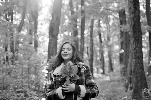 Autumn woman in autumn park with red pullover. Outdoor portrait Gorgeous brunette model girl with sunny day light. Copy space for text.