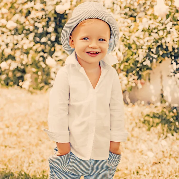 Cuidados infantis. Menino bonito brincalhão alegre criança engraçado rosto grimace. Retrato de menino sorridente feliz no fundo da natureza . — Fotografia de Stock