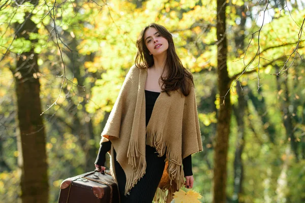 Menina de outono com mala andando sobre folhas e cair fundo de bordo amarelo. Mulher bonita em folhagem de outono, retrato de beleza . — Fotografia de Stock