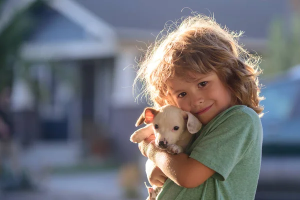 Child lovingly embraces his pet dog. Cute kids boy enjoying with her best friend dog. Positive emotions of children. — Stock Photo, Image