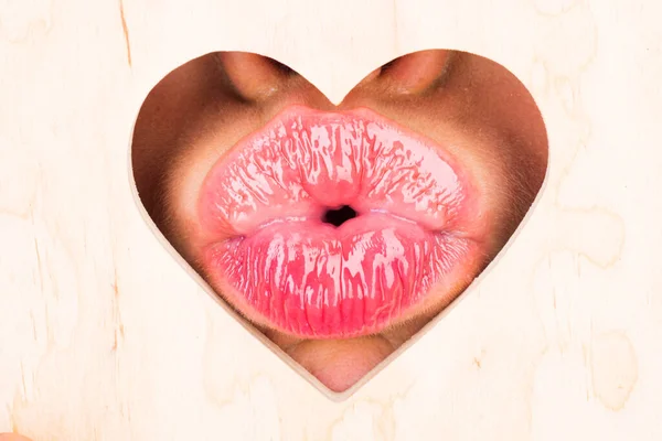 Lips in heart shape. Valentines day. Sensual womens kissing. Red lip with glossy lipgloss. Tongue and sexy kiss. Close up, macro with beautiful mouths.