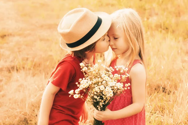 Feliz beso de niños encantadores en el campo de otoño. Lindos niños pequeños besándose y disfrutando en el campo. Historia de amor y cuidado de niños. Tarjeta de San Valentín. Concepto de infancia. —  Fotos de Stock