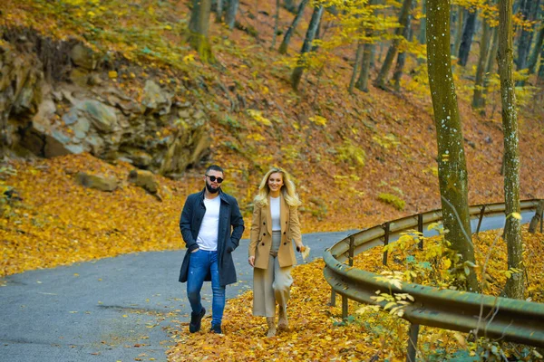 在秋天的公园里散步的年轻夫妇. — 图库照片