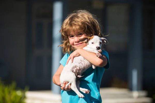 Hug friends, kid hugging dog. Happy child and puppy hugs with tenderness smiling. — Stock Photo, Image