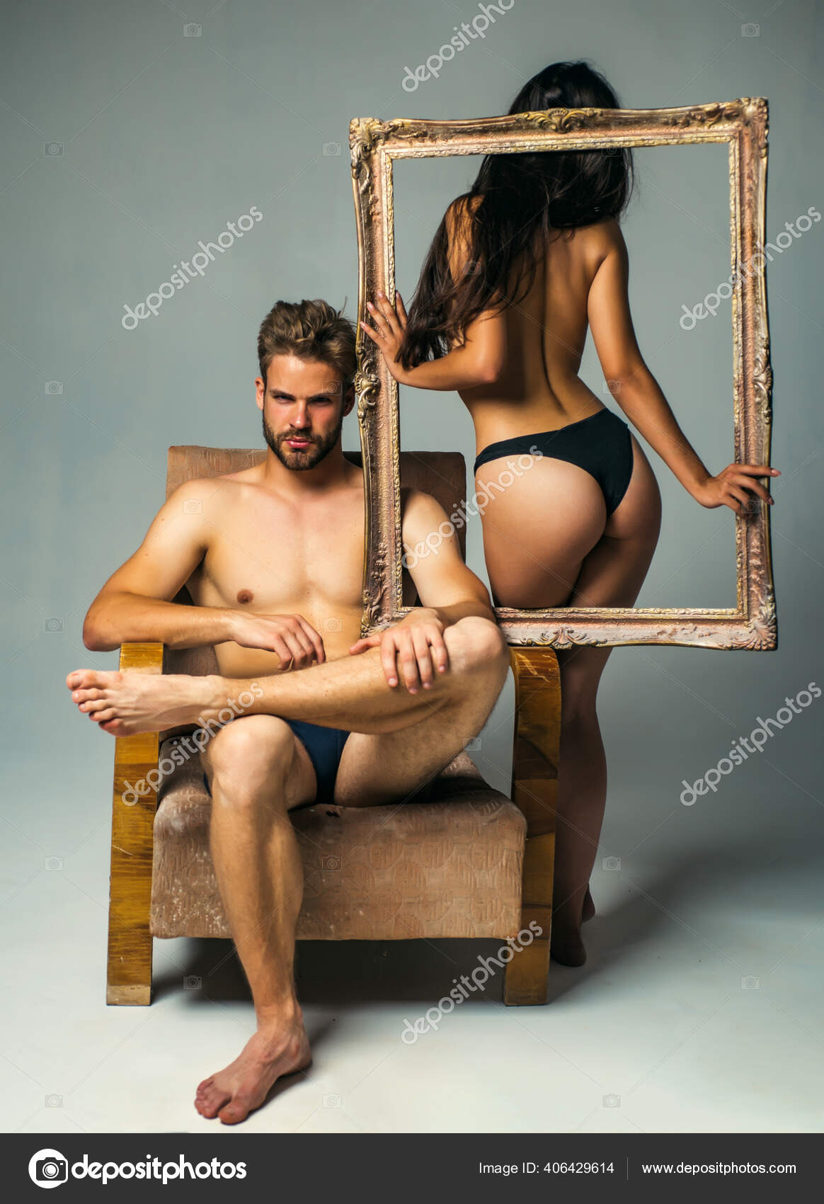 Attractive young couple holding picture frame. Attractive man and woman being playful. Erotic and spiritual feeling. Copy space. Young man and woman