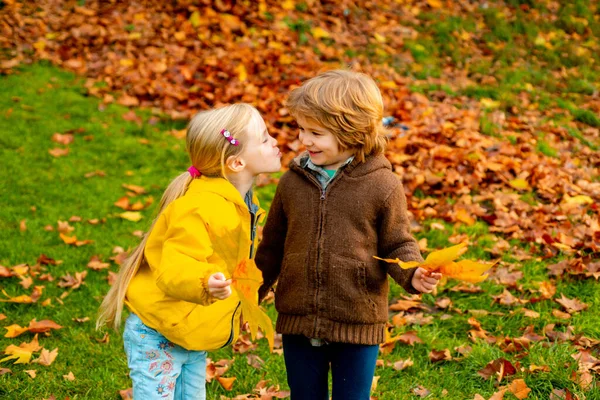 Kleines Mädchen küsst schönen kleinen Jungen im Freien. Kinder, Lebensstil der Kindheit. — Stockfoto