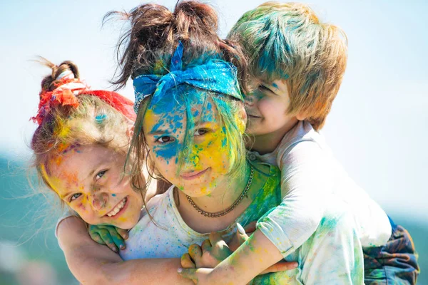 Children with paintings face. Happy children embracing each other and smiling.