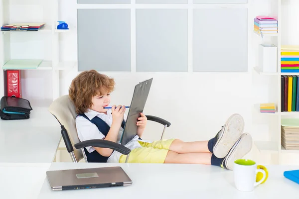 Successful Little kid boy businessman sitting in office. Child in suit like a freelancer. — Stock Photo, Image