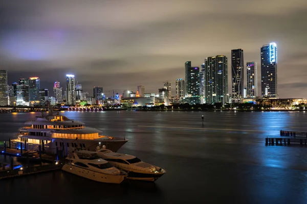 Iate ou barco ao lado do centro de Miami. Bela cidade colorida de Miami Florida horizonte e baía com nuvens noturnas. — Fotografia de Stock