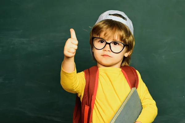 School children. Little children at school lesson. Education first. Schoolchild. Cheerful smiling child at the blackboard.