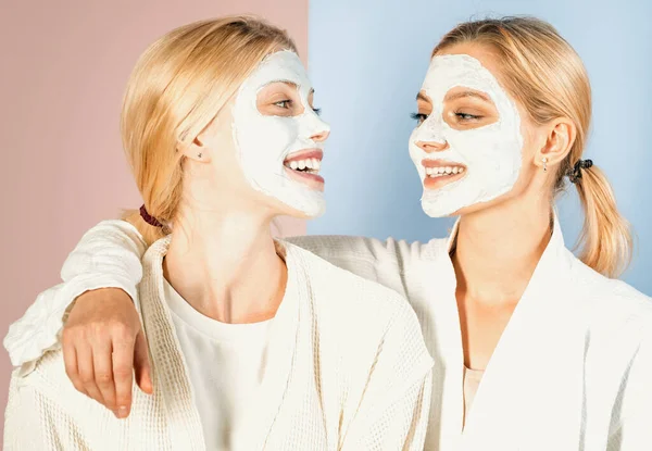 As mulheres jovens desfrutam de tratamento de máscara facial e se divertem com procedimentos de spa. Conceito de saúde e beleza. Melhores amigos fazendo procedimentos de spa e se divertindo. — Fotografia de Stock