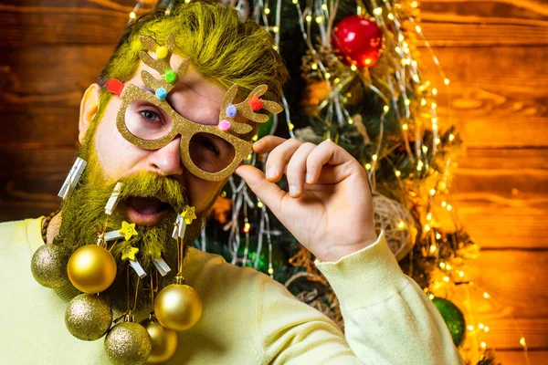 Gelukkige wintertijd. Kerstman winterportret. Fashion portret van knappe man binnen met kerstboom. Grappige Kerstman. — Stockfoto