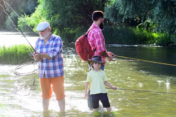 Nonno e nipote. Nonno con figlio e nipote che si divertono nel fiume. Giornata estiva. Hobby e attività sportive. — Foto Stock