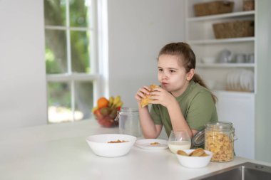 Kid eating healthy food at kitchen. Kids enjoying fresh fruits and vegetables. Happy kid having healthy breakfast. Cute kid eating tasty vegetarian healthy meal. Healthy organic food for kids