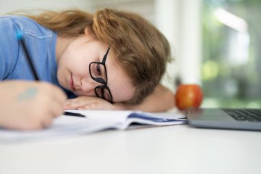 Child gaining knowledge in home school. Kid studying online lesson at home. Young student focused on education in home school. Boy learning new skills and knowledge during homeschool class