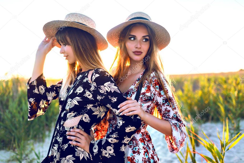 Young beautiful women in straw hats   on tropical island beach. 