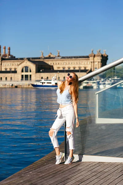 young beautiful woman posing by river in summer