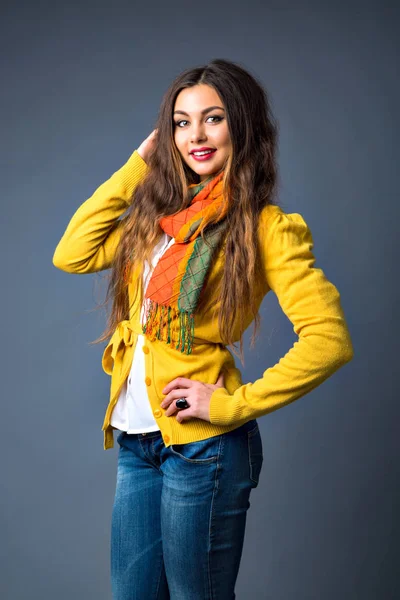 young beautiful woman in scarf posing in studio