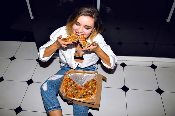 beautiful young woman eating pizza