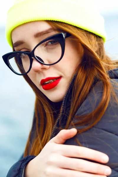young beautiful woman in neon hat   posing by river
