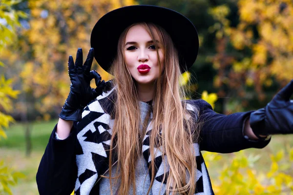 Красивая Улыбающаяся Девушка Шляпе Позирует Городском Парке Показывая Знак — стоковое фото