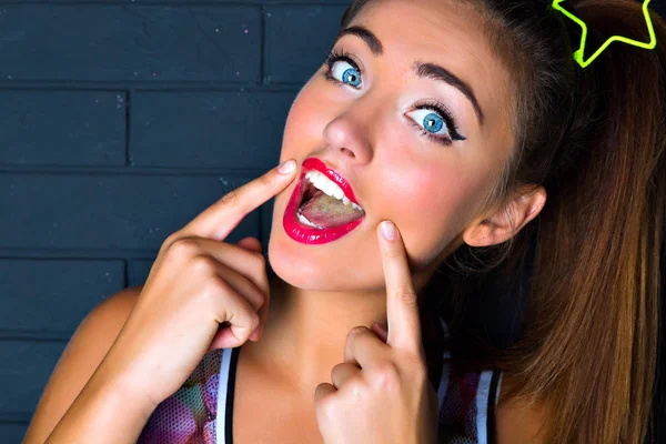 young beautiful woman showing smile gesture
