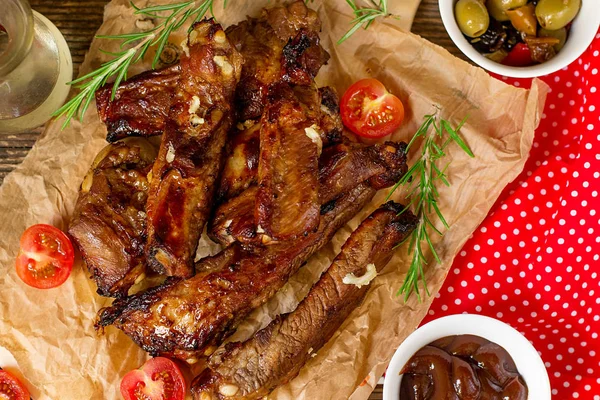 Baked barbecue glazed spare ribs of pork riblets with garlic and rosemary