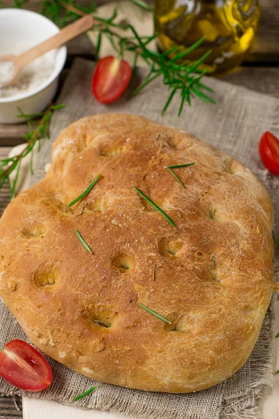 Flat oven-baked Italian bread Focaccia with rosemary and sea salt