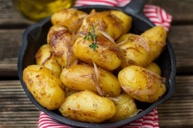 Roasted baby potatoes with onions caramelized in soya sauce clipart