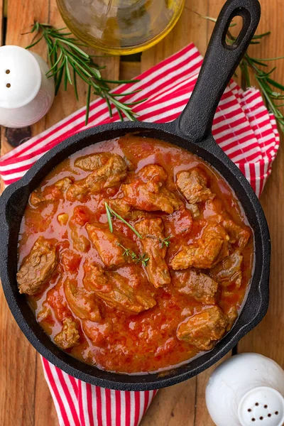 Beef stew with tomato sauce and cream and rosemary