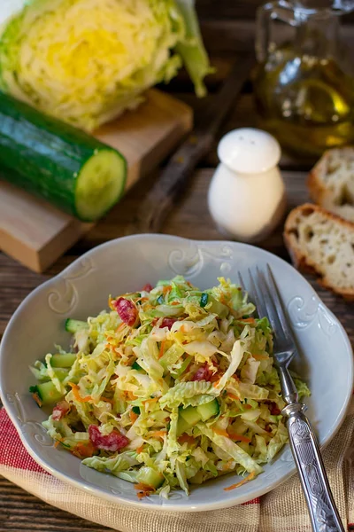 Fresh salad of napa cabbage with carrots, cucumber and salami — Stock Photo, Image