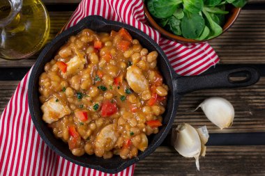 Chicken stew with navy beans and peppers in tomato sauce clipart