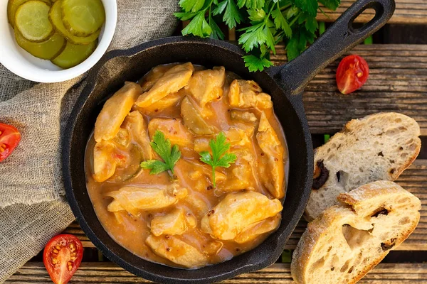 Chicken fricassee with pickles in white sauce with tomatoes — Stock Photo, Image