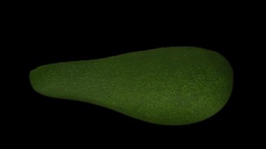 Siyah arka planda dönen yeşil Florida avokadosunun (ikiye bölünmüş) gerçekçi canlandırması. Video kusursuz bir şekilde döngüye giriyor ve nesne gerçek bir avokadodan 3D taranıyor..
