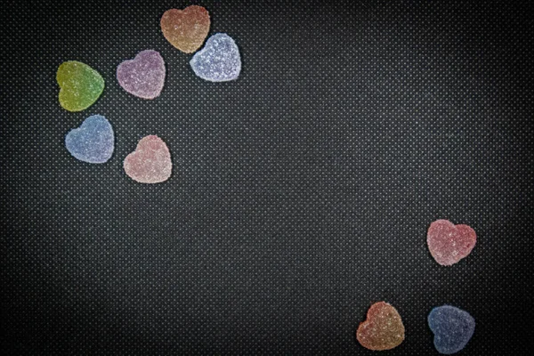 Heart candy on a black background, concept background, blank texture, textured design