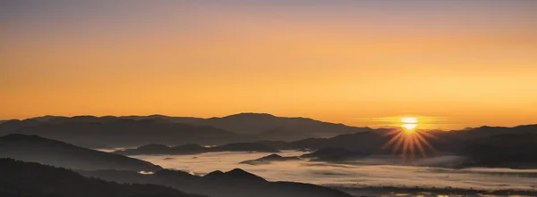 Beautiful foggy winter sunrise in mountains of north Thailand.