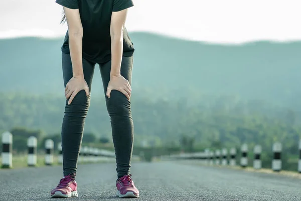 Young woman stop resting after running.