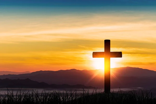 Silhouette of cross on mountain sunset background. — Stock Photo, Image