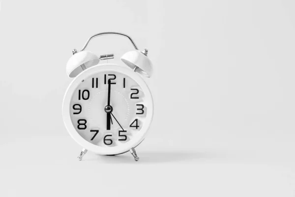 White vintage alarm clock on white background. — Stock Photo, Image