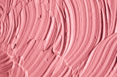 Pembe kozmetik kil (yüz maskesi, krem) doku yakın kadar seçici odak. Fırça darbeleri ile arka plan. 