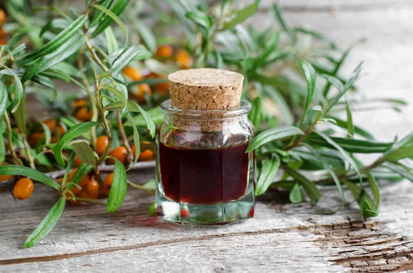 Small glass bottle with sea buckthorn oil (tincture, infusion, extract).