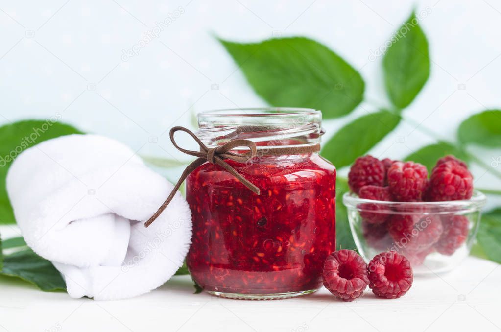 Homemade raspberry face and body mask/scrub in a glass jar. DIY cosmetics and spa. Copy space.  