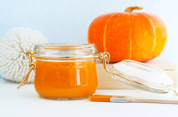 Homemade pumpkin face mask in a glass jar. DIY cosmetics and spa. Copy space.