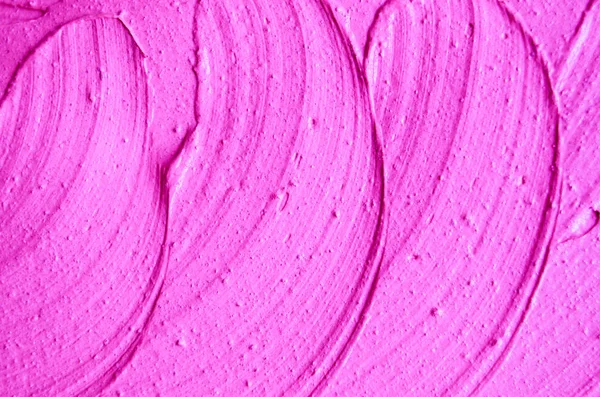 Neon pink face cream/mask/body wrap texture close up. Selective focus. Magenta abstract background with brush strokes.