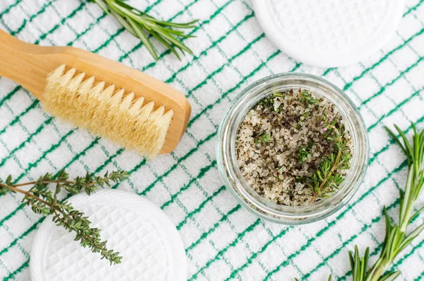 Homemade herbal scrub (foot soak or bath salt) with rosemary, thyme, sea salt and olive oil. Natural skin and hair care. DIY beauty treatments and spa recipe. Top view, copy space